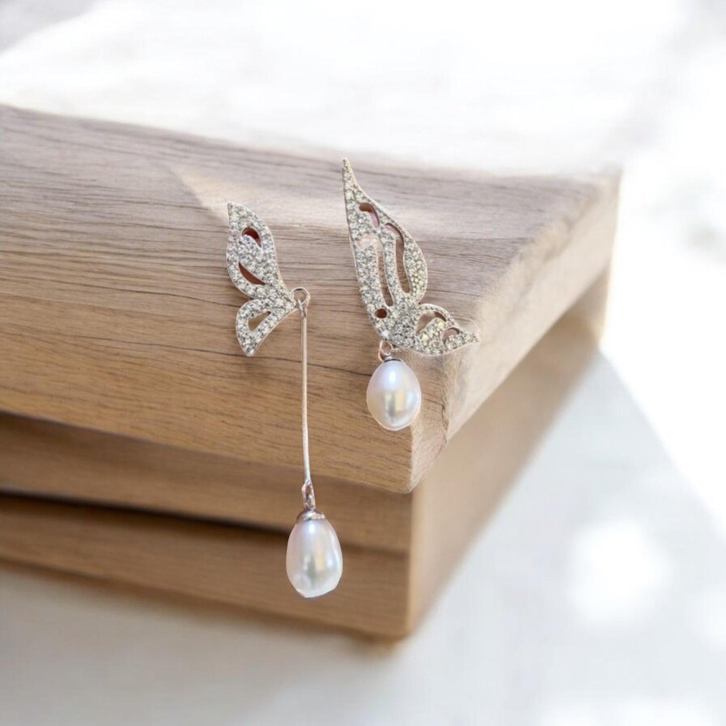 Asymmetrical butterfly pearl earrings